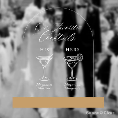 Decorative sign with cocktail illustrations and text 'Our Favorite Cocktails' on a blurred background.